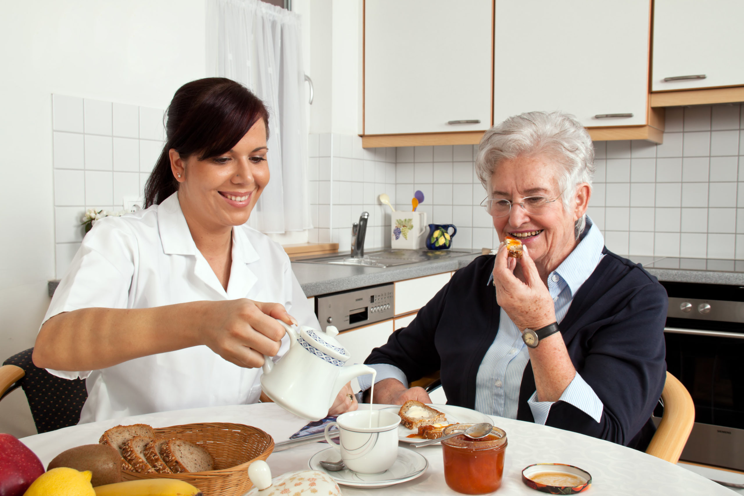 Caregiver serving Tea to Elder woman